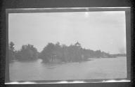 [View of shore along river]