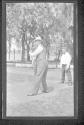 [Man playing baseball with boys]