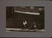 People Walking Against Building
