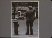 Man Standing by Fire Hydrant