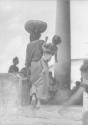 [Woman carrying child]