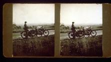 [Man standing by two motorcycles, California trip]
