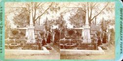[Two women in cemetery near monument]
