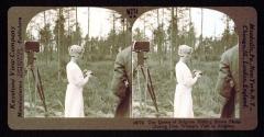 The Queen of Belgium making stereo photo during Pres. Wilson's visit to Belgium.