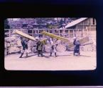 Four Men Carrying Lumber