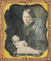[Mother holding deceased baby]