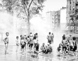 [Group of children in park sprinkler]