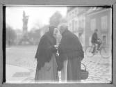 2 Women Conversing in Street