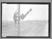 [Man Repairing Semaphore]