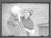 [Young Girl Holding Baby]