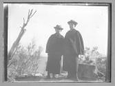 [Two people in overcoats]