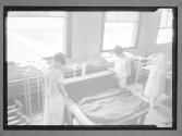 [Two Women Measuring Cloth]