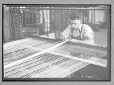 [Man at Table Loom]