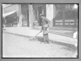 Old Fashioned Street Sweep at work