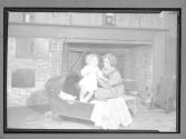 [Girl Scout cooking at fireplace]