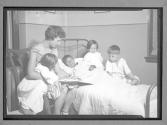 [Woman Reading to Children]
