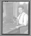 [Man Cutting Fabric by Hand]