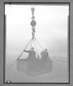 Two Men in Derrick Lift