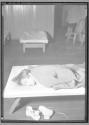 [Boy Sleeping on Cot]
