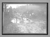 [auto tour, driving through mud hole]