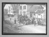 [people surrounding auto in front of residence]