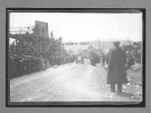 [auto racing across start-finish line]
