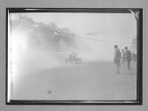 [auto racing across start-finish line]