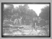 [people near wood pile]