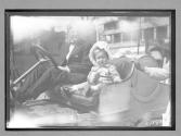 [Man with child in auto]