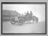 [auto racers reving engine at track]