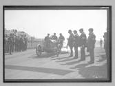 [auto racer with inspectors at track "#6"]