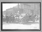 [auto tourist in town with spectators]