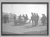 [judges inspecting auto at racetrack "#2"]