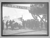 [auto at start-finish line with judges "#8"]