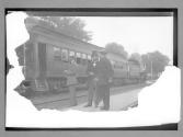 [two men in front of train]