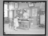 [Schoolroom, Teacher And Girl]