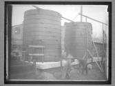 [Men Working Near Storage Tanks]