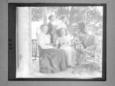[Group Portrait, Gertrude G. Fisher With People (Garrison's) On Porch]
