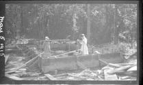 Girls standing inside building under construction, Oak Lodge Trip
