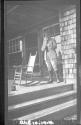 Man standing on porch, Oak Lodge Trip