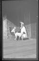 Maria Eastman and woman with dog outside house, Oak Lodge Trip
