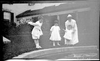 Woman in Eastman's garden with Dryden children and Watson Newhall