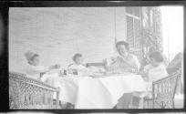 Nell Newhall on porch with children