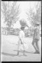 Native girl carrying burden on her head, Jamaica Trip