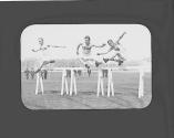 Men jumping hurdles