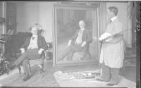 George Eastman and Charles Hopkinson with painting in conservatory