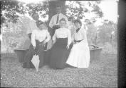Oak Lodge guests sitting on bench around tree