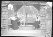 Hubbells and Mary Mulligan in gazebo with dog, Oak Lodge Trip