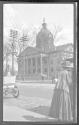 [Street scene outside domed building]