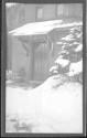 [Front of snow covered house (out of focus)]